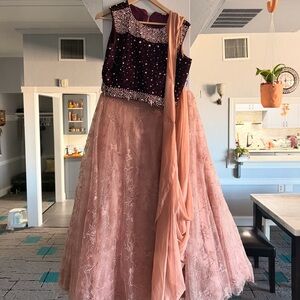 Pink lengha with purple bedazzled blouse